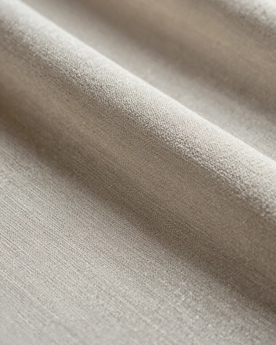 Macro studio photograph of loom-woven silk fabric surface, visible weave structure and fiber sheen, soft directional day